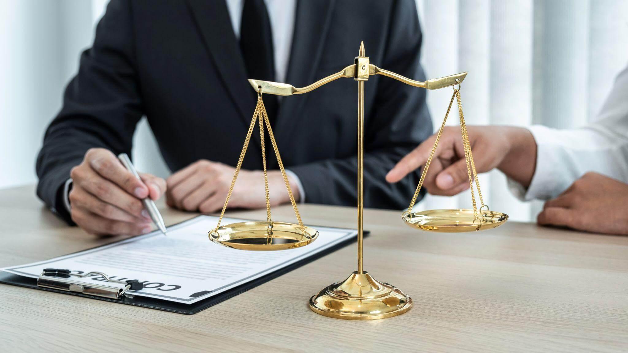 Man in suit with a scale and pen, symbolizing