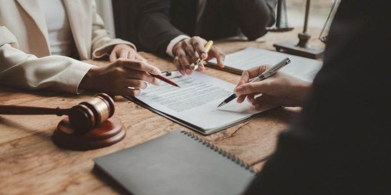 Two people at a table discussing legal options for a