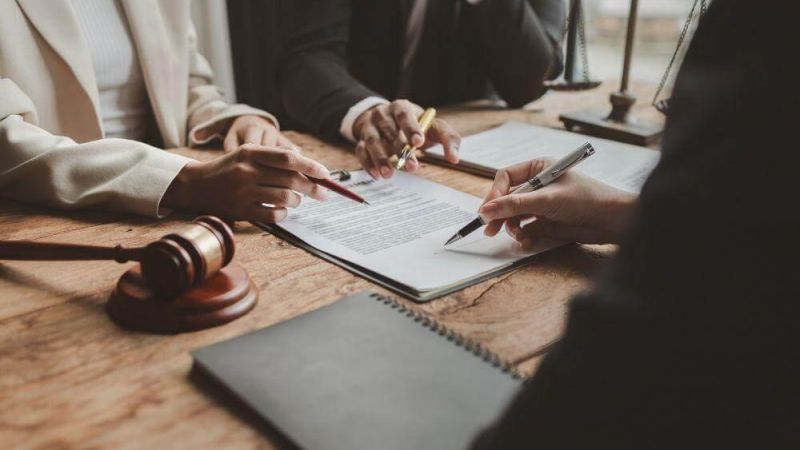 Two people at a table discussing legal options for a